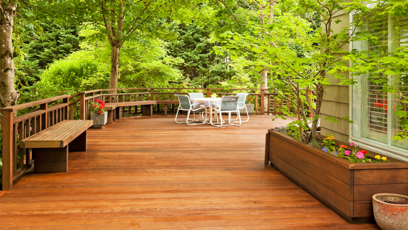 A wooden deck with a table and chairs