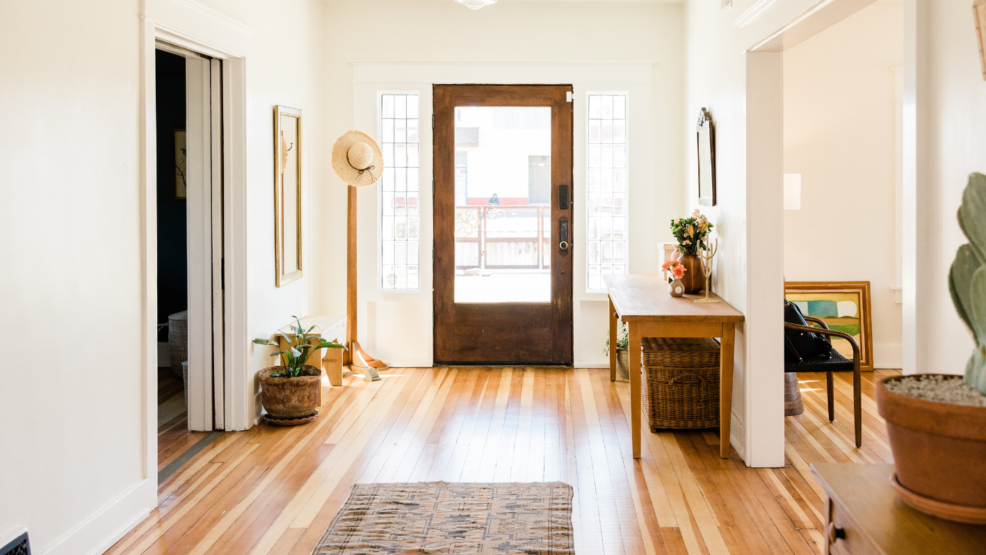 A hallway with a wooden floor and a wooden door