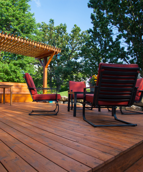 A wooden deck with two chairs and a table